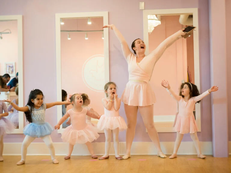 Children dancing and laughing with their Ballet Teacher.