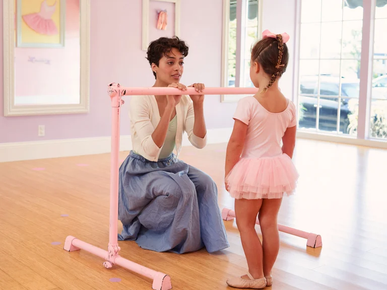 ballet teacher with child at barre
